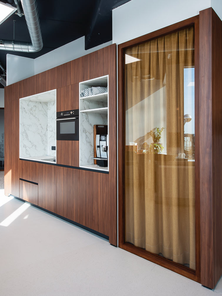 A curtain separates the stylish marble-effect kitchenette from a brainstorming area. 